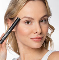 Woman holding eyebrow conditioner