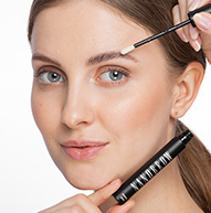 Blonde girl holding eyebrow conditioner