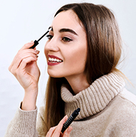 Model in a beige turtleneck sweater using Nanobrow Eyebrow serum
