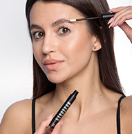 Woman using eyebrow serum