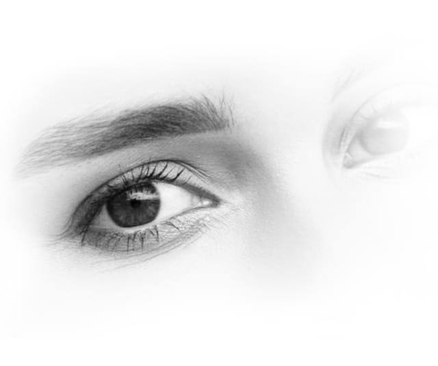 Black & white picture of eyes, one is more faded